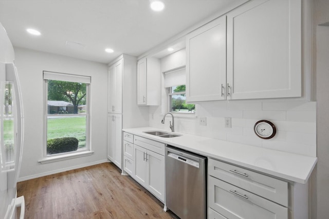 kitchen featuring a sink, baseboards, plenty of natural light, and dishwasher