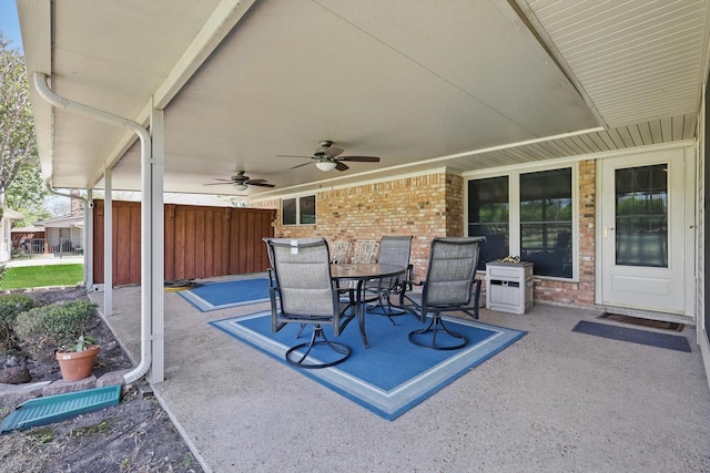 view of patio with outdoor dining area and a ceiling fan