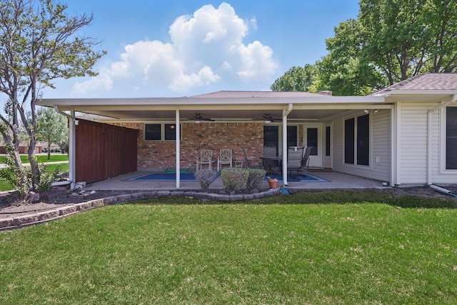 back of house featuring a patio area, brick siding, a ceiling fan, and a lawn