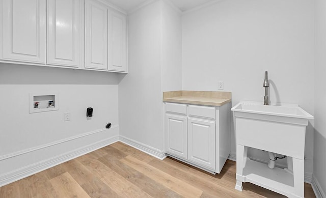 laundry room with light wood-type flooring, cabinet space, ornamental molding, and hookup for a washing machine