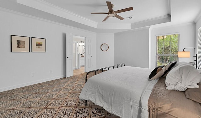 carpeted bedroom with baseboards, visible vents, ceiling fan, crown molding, and a raised ceiling