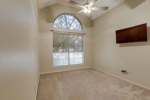 unfurnished room with baseboards, a ceiling fan, carpet floors, and vaulted ceiling