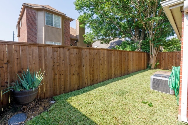 view of yard with a fenced backyard and cooling unit