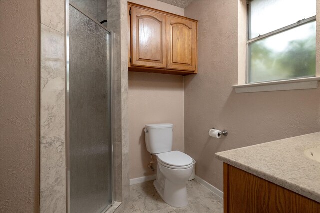 bathroom with vanity, baseboards, a stall shower, and toilet