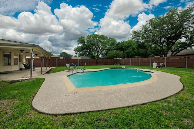 view of pool featuring ceiling fan, a fenced in pool, a fenced backyard, a yard, and a patio