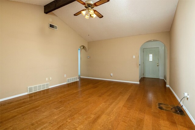 spare room featuring arched walkways and visible vents