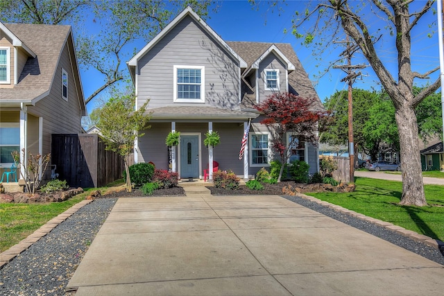 traditional-style house with a front yard and fence
