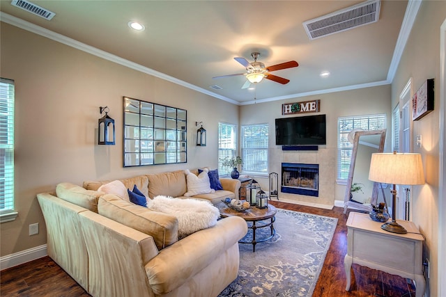 living room with visible vents, baseboards, a ceiling fan, and a fireplace