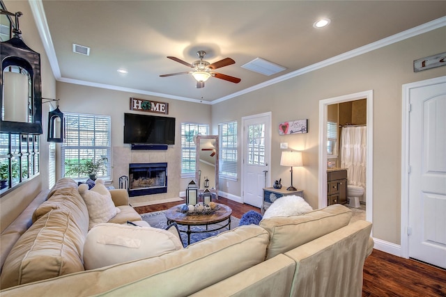 living room featuring a tiled fireplace, baseboards, a ceiling fan, and visible vents
