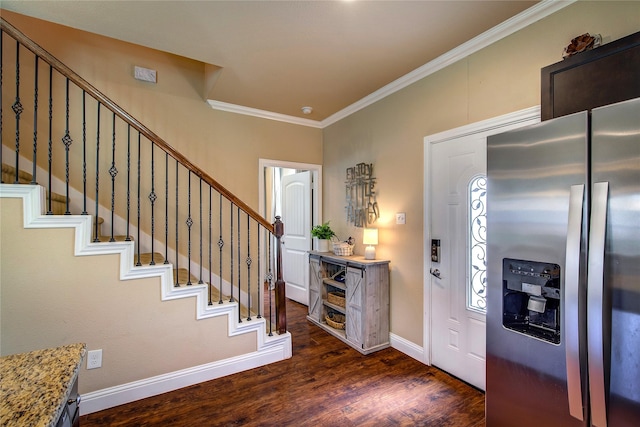 foyer featuring ornamental molding, baseboards, stairs, and dark wood-style floors