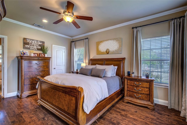 bedroom with dark wood-type flooring, visible vents, multiple windows, and crown molding