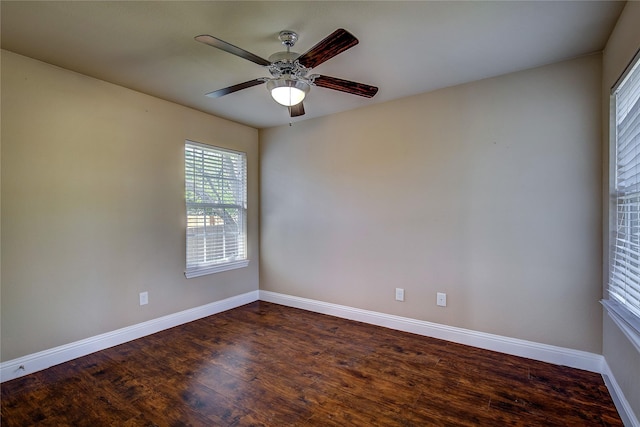unfurnished room featuring dark wood finished floors, baseboards, and ceiling fan