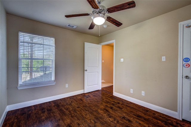 interior space with wood finished floors, ceiling fan, baseboards, and visible vents