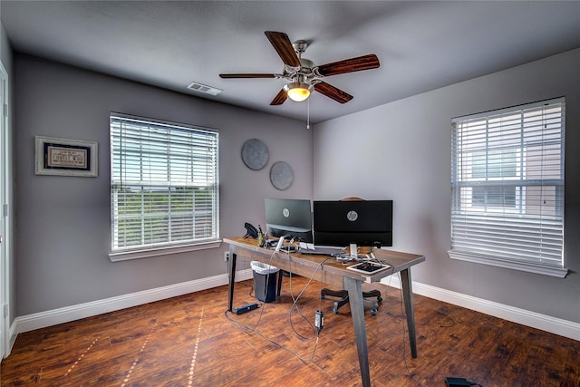 home office featuring wood finished floors, baseboards, a ceiling fan, and visible vents