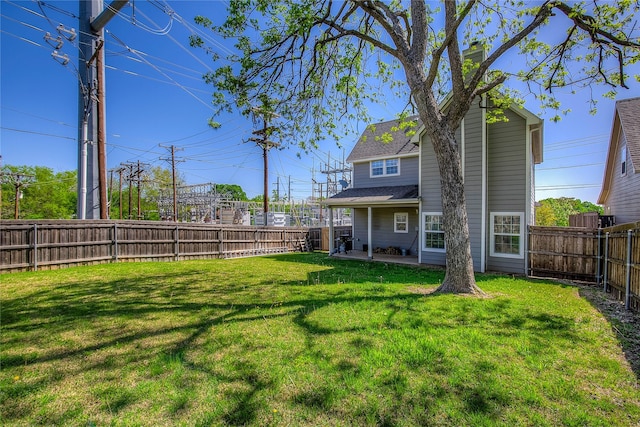 view of yard with a patio area and a fenced backyard