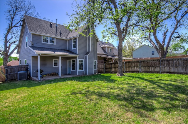 back of house with a shingled roof, a lawn, a fenced backyard, a patio, and central air condition unit