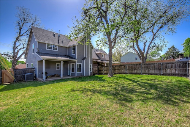 back of house with a patio, a lawn, cooling unit, a fenced backyard, and a shingled roof