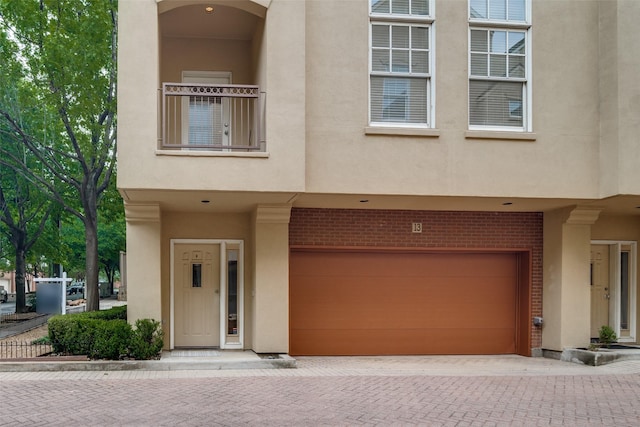 3251 Cambrick St Unit 13, Dallas, TX 75204 - townhome / multi-family property with an attached garage, brick siding, decorative driveway, and stucco siding