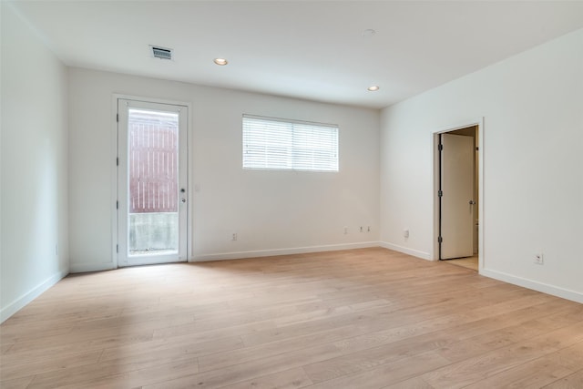 3251 Cambrick St Unit 13, Dallas, TX 75204 - empty room featuring baseboards, light wood-style flooring, visible vents, and a wealth of natural light
