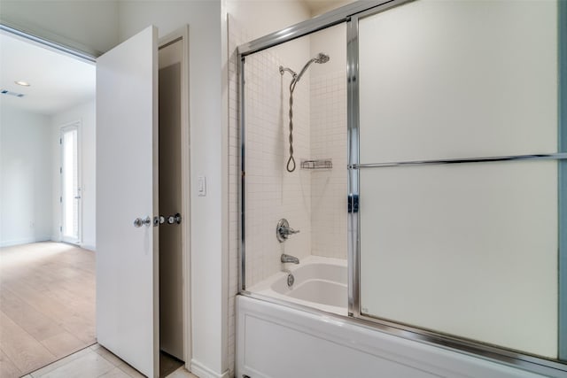 3251 Cambrick St Unit 13, Dallas, TX 75204 - bathroom featuring baseboards, visible vents, and bath / shower combo with glass door