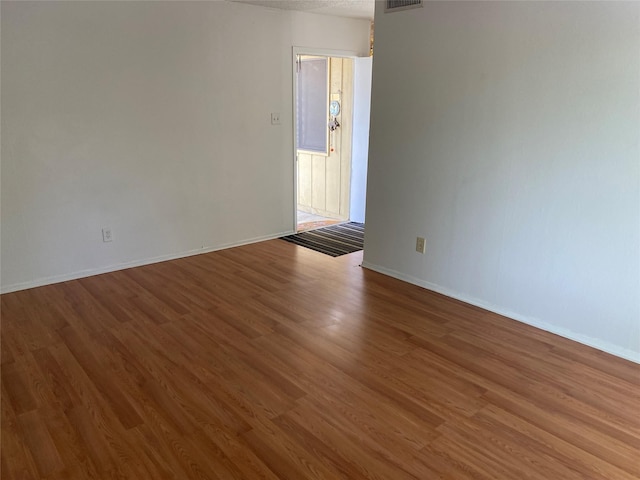 5607 Harvest Hill Rd Unit 2008, Dallas, TX 75230 - empty room with wood finished floors, baseboards, and visible vents