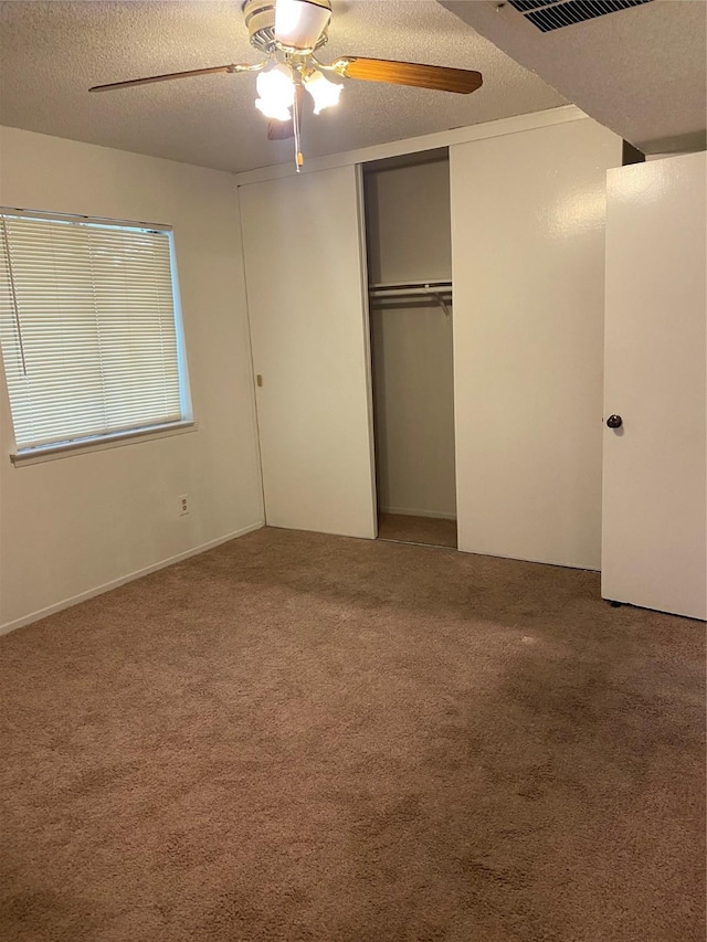 5607 Harvest Hill Rd Unit 2008, Dallas, TX 75230 - unfurnished bedroom with a closet, visible vents, ceiling fan, carpet, and a textured ceiling
