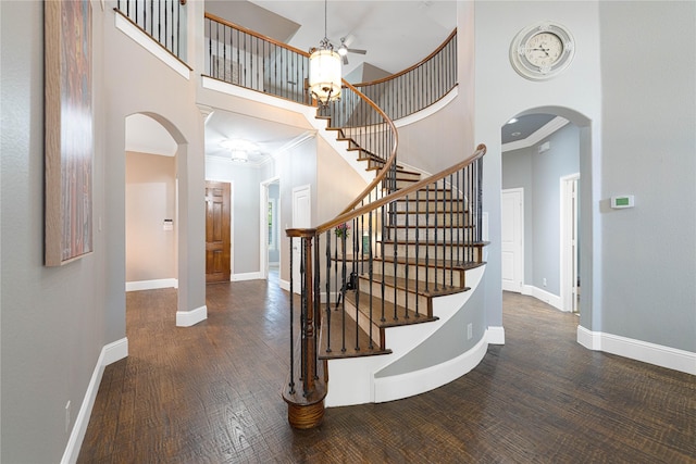 523 Buffalo Bend Ct, Murphy, TX 75094 - staircase with ceiling fan, arched walkways, a towering ceiling, wood finished floors, and baseboards