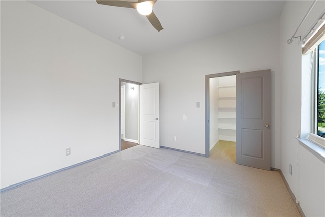 523 Buffalo Bend Ct, Murphy, TX 75094 - unfurnished bedroom featuring light carpet, a walk in closet, multiple windows, and a ceiling fan