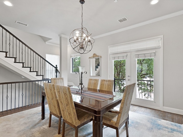 dining area with visible vents, a wealth of natural light, and wood finished floors