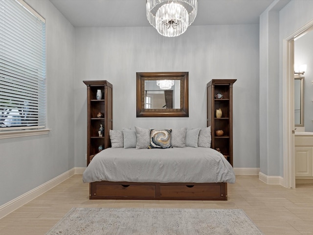 bedroom with baseboards and an inviting chandelier