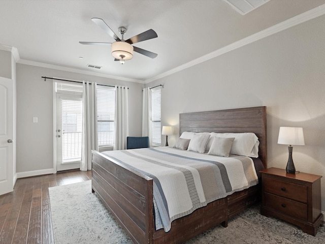 bedroom featuring baseboards, visible vents, ornamental molding, and hardwood / wood-style floors