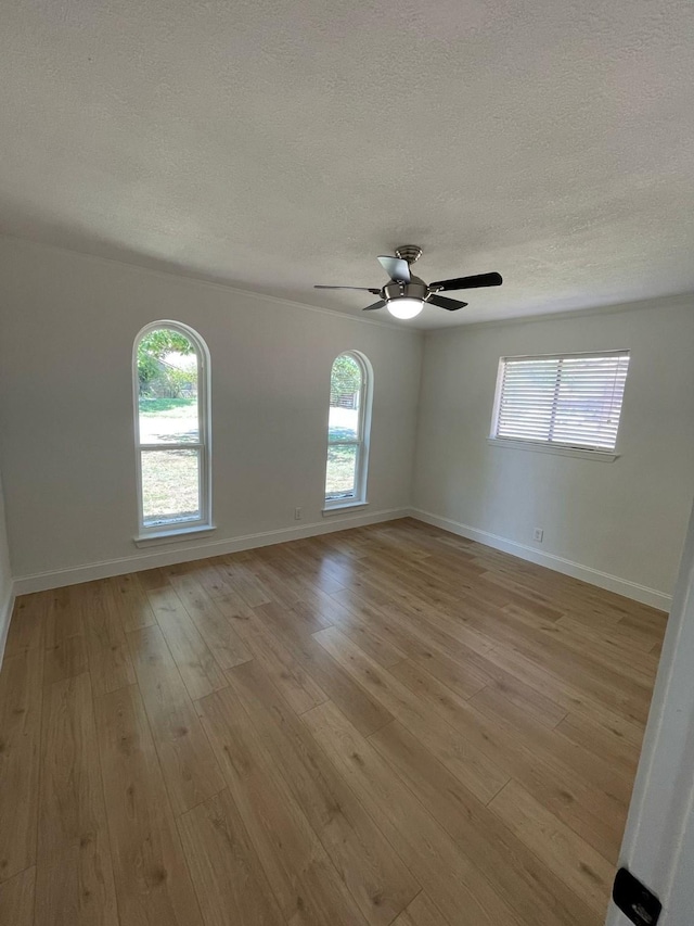 spare room featuring a wealth of natural light and a textured ceiling