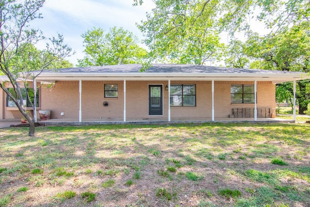 503 W College St, Rising Star, TX 76471 - back of house featuring brick siding and a lawn
