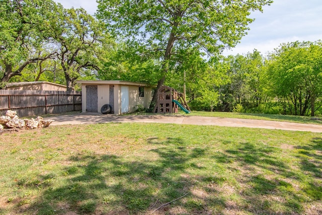 503 W College St, Rising Star, TX 76471 - view of yard featuring fence, a playground, and an outbuilding