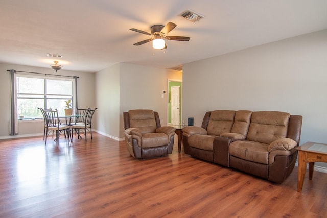 503 W College St, Rising Star, TX 76471 - living area with light wood finished floors, visible vents, baseboards, and ceiling fan