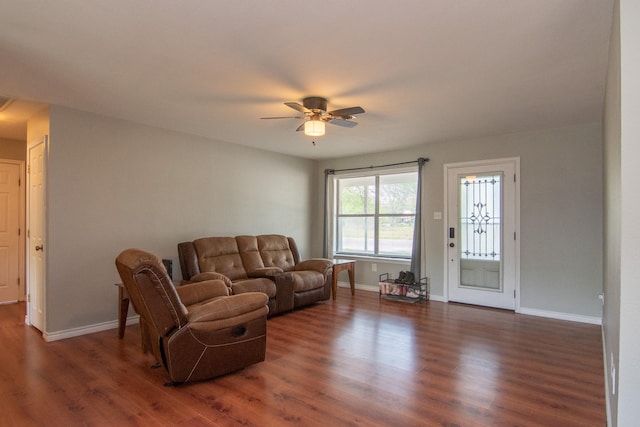 503 W College St, Rising Star, TX 76471 - living room featuring ceiling fan, baseboards, and dark wood-style floors
