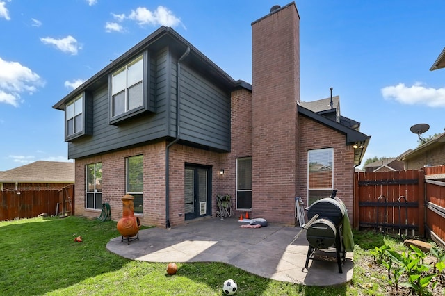 2313 Suntree, Flower Mound, TX 75022 - back of property with a chimney, a patio area, and brick siding