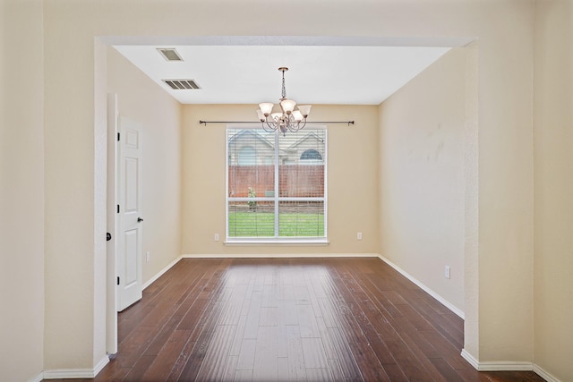 2313 Suntree, Flower Mound, TX 75022 - spare room featuring a chandelier, dark wood-type flooring, and baseboards