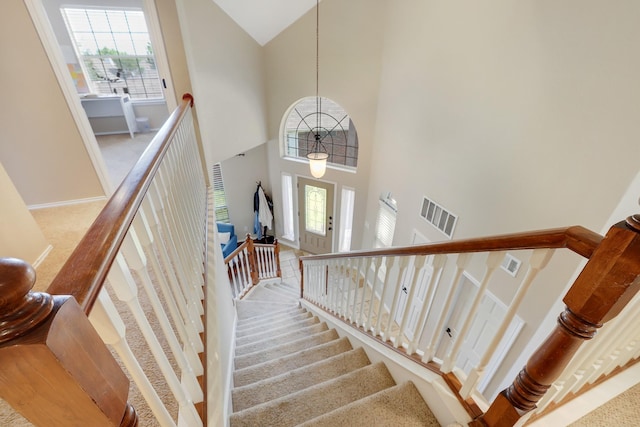 2313 Suntree, Flower Mound, TX 75022 - stairs with carpet flooring, a high ceiling, and baseboards