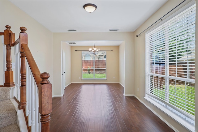 2313 Suntree, Flower Mound, TX 75022 - unfurnished room featuring a chandelier, dark wood-style floors, baseboards, and stairway