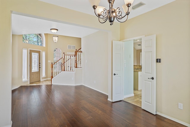 2313 Suntree, Flower Mound, TX 75022 - entryway with a chandelier, stairway, wood finished floors, a high ceiling, and baseboards