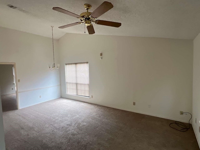 unfurnished room with ceiling fan with notable chandelier, baseboards, vaulted ceiling, and carpet floors