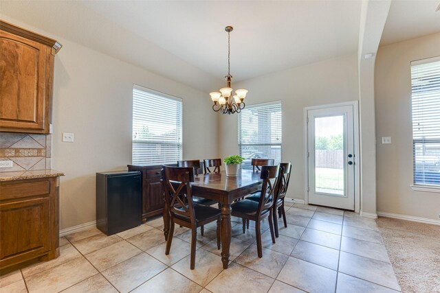 109 Thoroughbred St, Waxahachie, TX 75165 - dining room featuring light tile patterned floors, a notable chandelier, baseboards, and a wealth of natural light