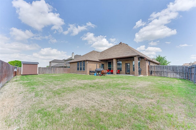 109 Thoroughbred St, Waxahachie, TX 75165 - rear view of house featuring a storage shed, a fenced backyard, an outdoor structure, a lawn, and brick siding
