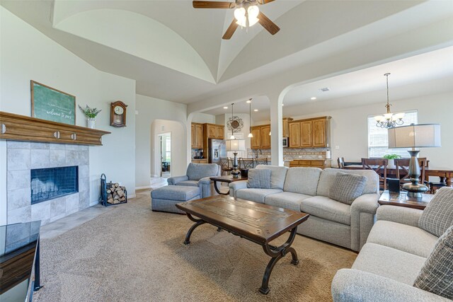 109 Thoroughbred St, Waxahachie, TX 75165 - living area with ceiling fan with notable chandelier, a fireplace, arched walkways, vaulted ceiling, and recessed lighting