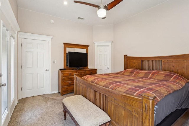 carpeted bedroom with visible vents and a ceiling fan