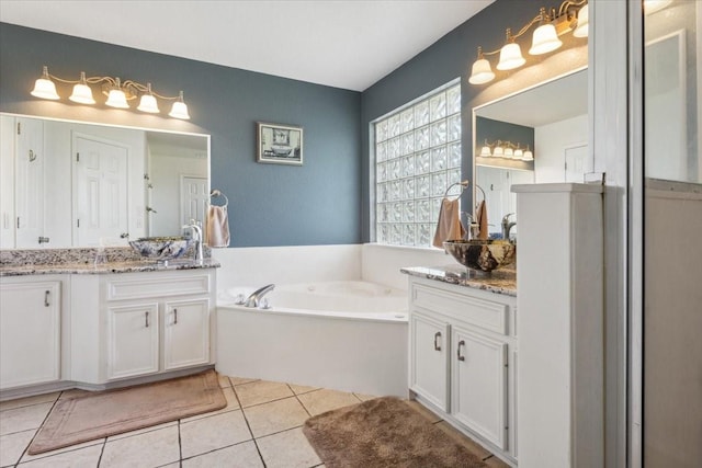full bathroom with a bath, tile patterned floors, and vanity