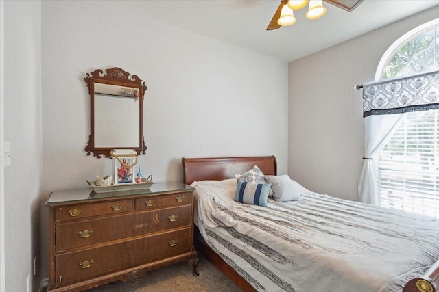 bedroom featuring a ceiling fan and carpet