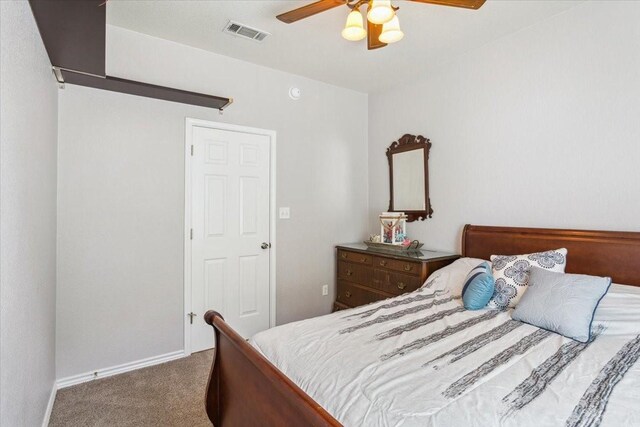 carpeted bedroom with baseboards, a ceiling fan, and visible vents