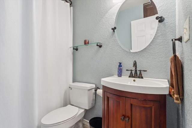 full bath featuring toilet, curtained shower, a textured wall, and vanity
